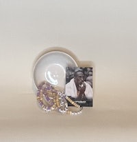 a plate with a picture of a man and a bracelet