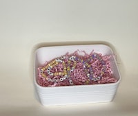 a white box with beads in it on a white surface